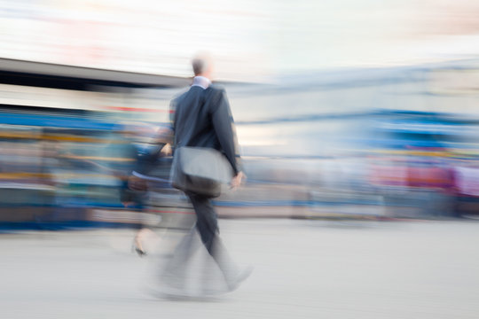 Motion blurred image of businessman rushing to office