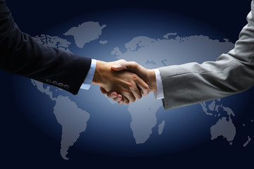 Handshake with map of the world in background