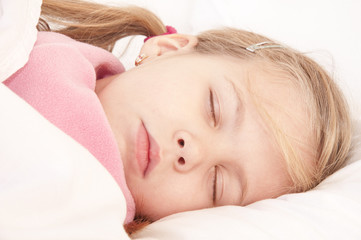 Fototapeta na wymiar Sleeping little girl on bed