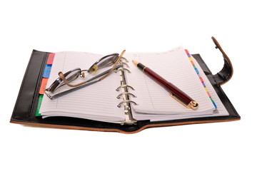 Planner, pen and eyeglasses