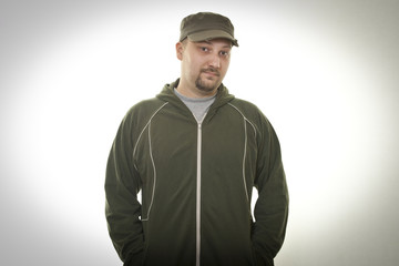 man in jacket and cap posing