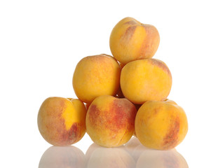 A pile of yellow-red colored peaches on white