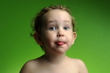 Portrait of cute little boy showing his tongue