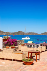 Fototapeta na wymiar Chairs at sea view relaxation area of luxury hotel, Crete, Greec
