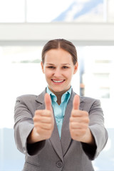 Proud businesswoman doing thumbs up