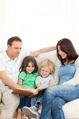 Cheerful family looking at a photo album together