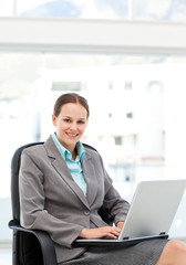 Pretty businesswoman working at her desk with a laptop