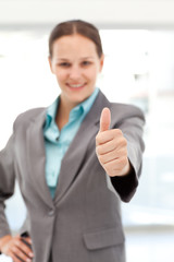 Young female executive doing a thumbs up