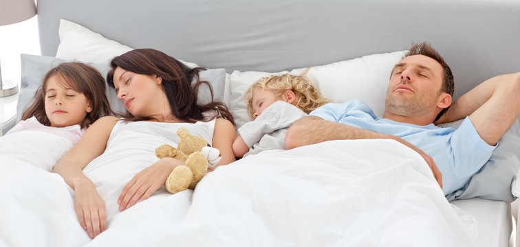 Cute family sleeping together