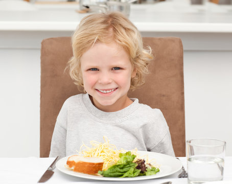 Cute Little Boy Eating Pasta And Salad