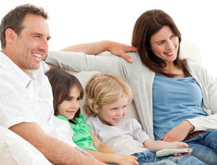 Parents and children watching television together