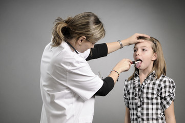 doctor examining girl mouth