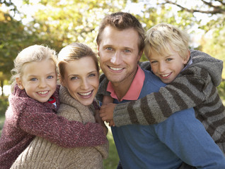 Fototapeta premium Young family pose in park