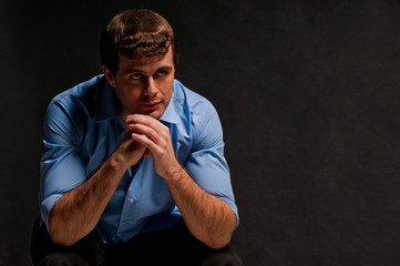 Elegant business man in a blue shirt, studio portrait