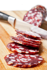 Salami sliced on chopping board