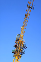 Naklejka premium tower crane under the blue sky