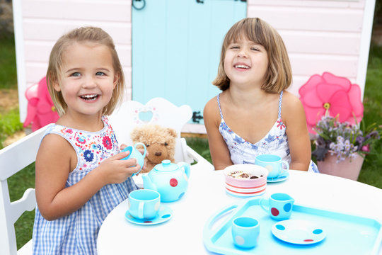 Two young girls play outdoors
