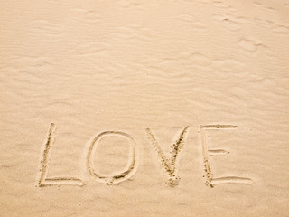 Fototapeta na wymiar Love Written in the Sand on a Sunny Day