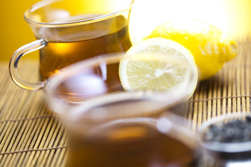 Glass cup of tea with lemon