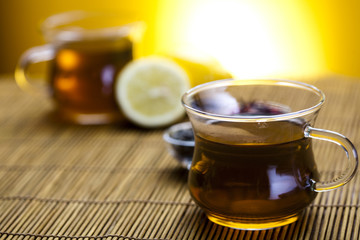 Glass cup of tea with lemon