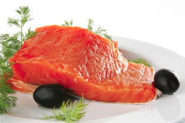 smoked salmon on white plate with olives