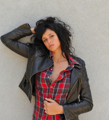 Depressed and lonely woman against a wall.