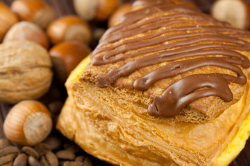 cake with chocolate, coffee beans and nuts lying on a bamboo mat