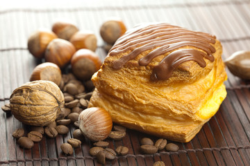 cake with chocolate, coffee beans and nuts lying on a bamboo mat