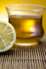 Glass cup of tea with lemon