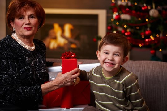 Grandmother and grandchild holding gift
