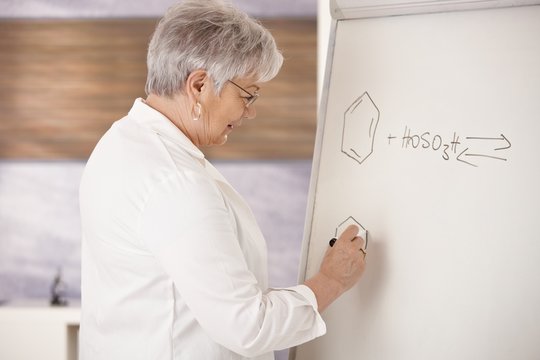 Senior teacher drawing on whiteboard