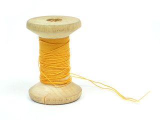 The spool of yellow threads