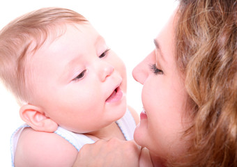 Happy young mother kissing a baby