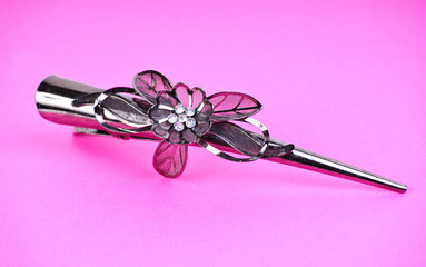 Hair-pin on the pink isolated background