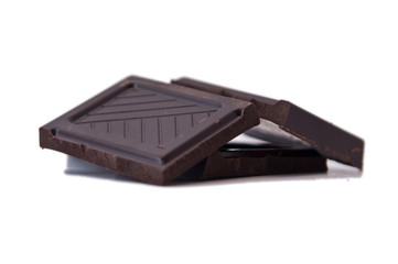 Squares of dark chocolate isolated on white