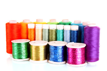 Semicircle of many-coloured bobbins of thread isolated on white