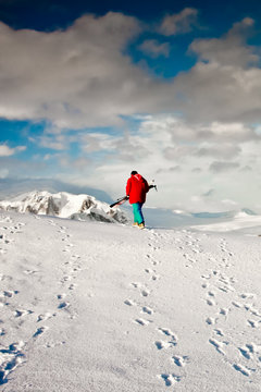 Man climbs on a snow slope