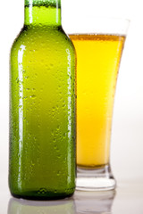 Green bottle of beer and glass