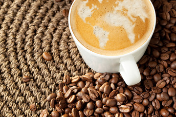 Cup of cappuccino with world map formed by milk foam