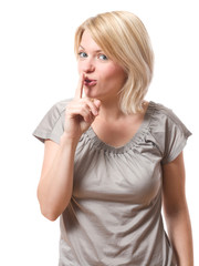 young woman saying shh with finger on lips isolated