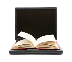 The Open Book Laying On The Laptop