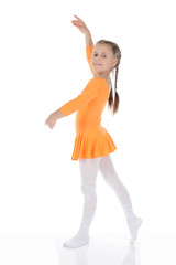 beautiful ballerina dancing in an orange dress.