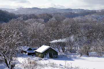 Winter landscape with the rural house (island Sakhalin)