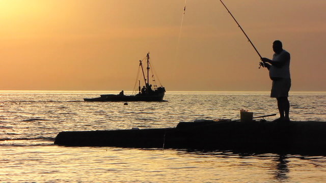 Silhouette of Fisherman at sunset.