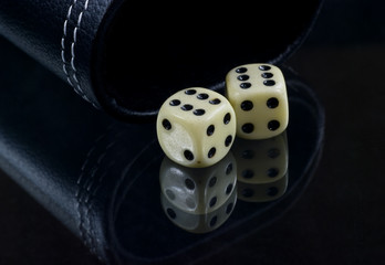 Two dice on black