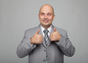 Bald businessman in a gray suit