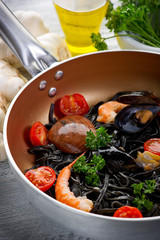 casserole with pasta tagliolini ink squid-tagliolini nero seppia