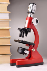 books and microscope, scientific or educational concept