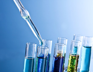 Test tubes closeup on blue background. Drops from test stick