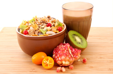 Yoghurt, muesli, milk and fruits on wooden surface isolated on w